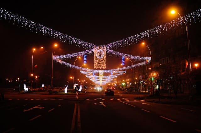 Road at night with Christmas lights over the top.