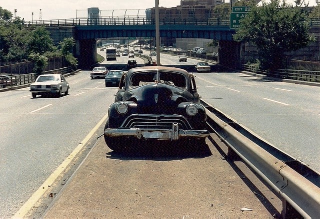 Oldsmobile broken down on the highway.