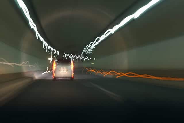 Person driving in a tunnel.