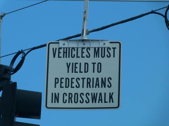 Yield to pedestrians street sign